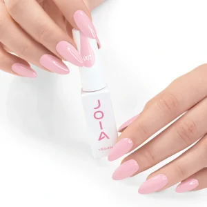 JOIA Vegan Gel Polish 007 Delicate Baby Pink 6ml — hand holding bottle with painted nails