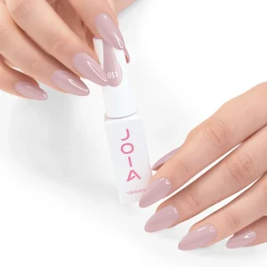 JOIA Vegan Gel Polish 011 Soft Dusty Pink Nude 6ml — hand holding bottle with painted nails