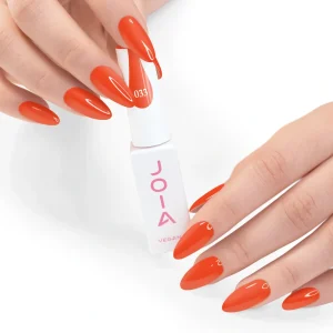JOIA Vegan Gel Polish 033 Tangerine Orange 6ml — hand holding bottle with painted nails