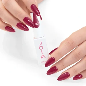 JOIA Vegan Gel Polish 040 Deep Wine Red 6ml — hand holding bottle with painted nails