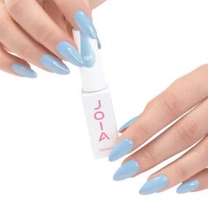JOIA Vegan Gel Polish 169 Baby Blue 6ml — hand holding bottle with painted nails